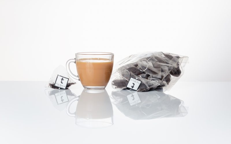 A brewed cup of Chocolate Bunny tisane sat next to Chocolate Bunny pyramid teabags