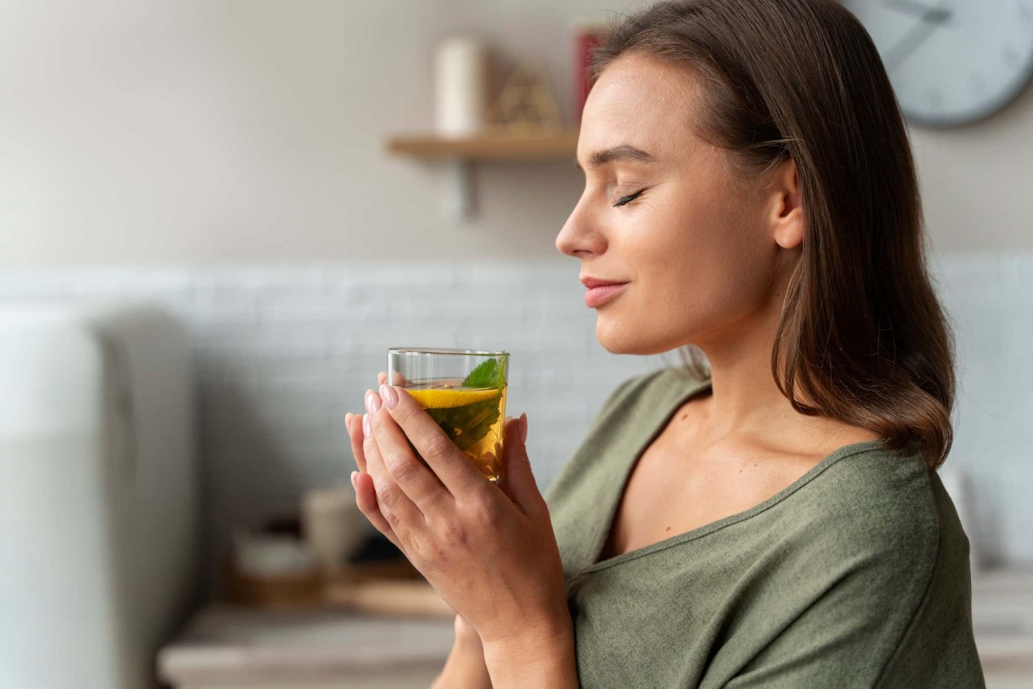 A woman experiencing the pleasurable tastes of soothing green tea.